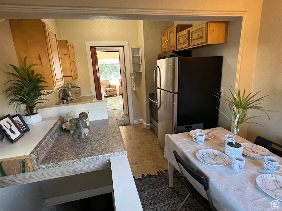 Kitchen featuring appliances with stainless steel finishes and tile patterned floors