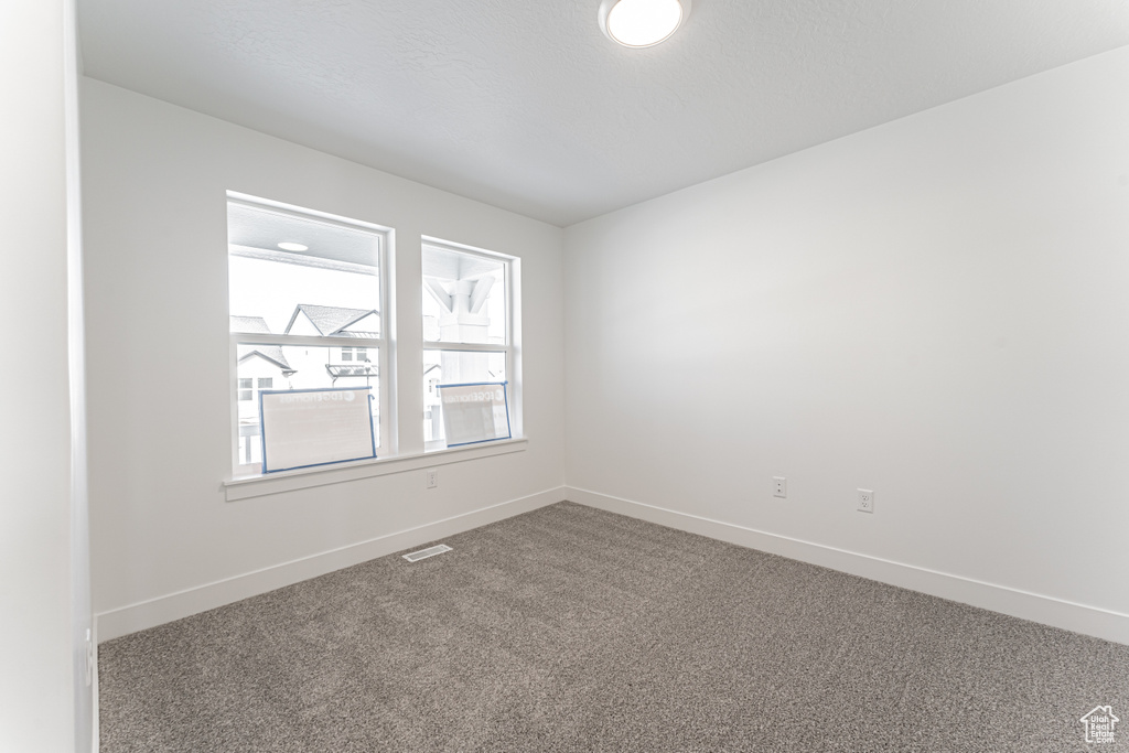 Unfurnished room featuring carpet