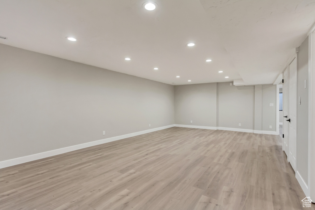 Basement with light wood-type flooring