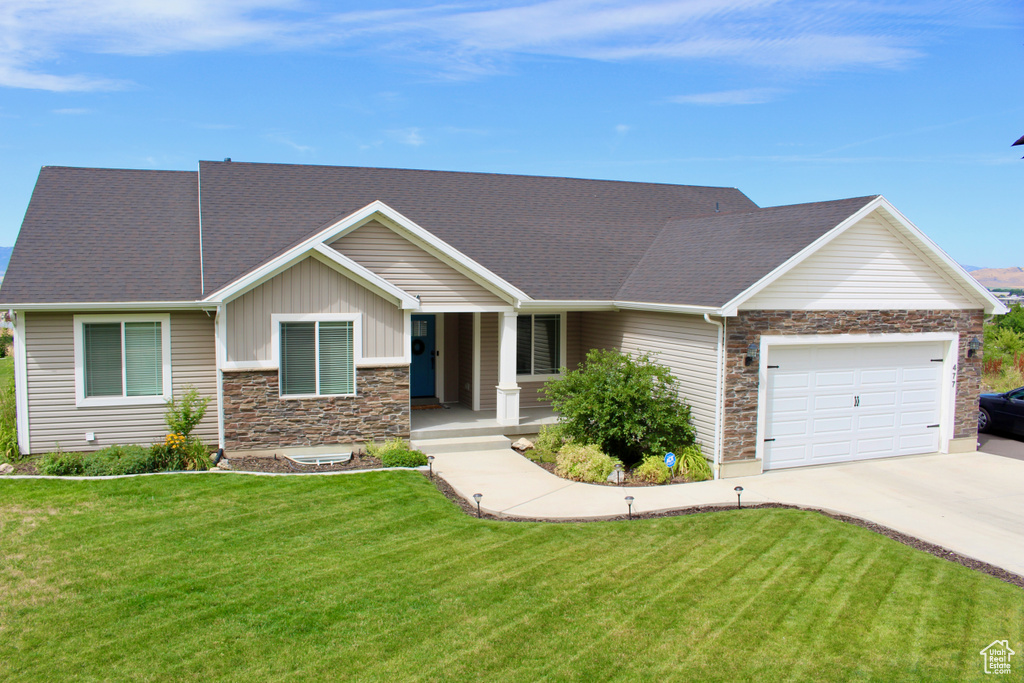 View of front of property with a garage and a front yard