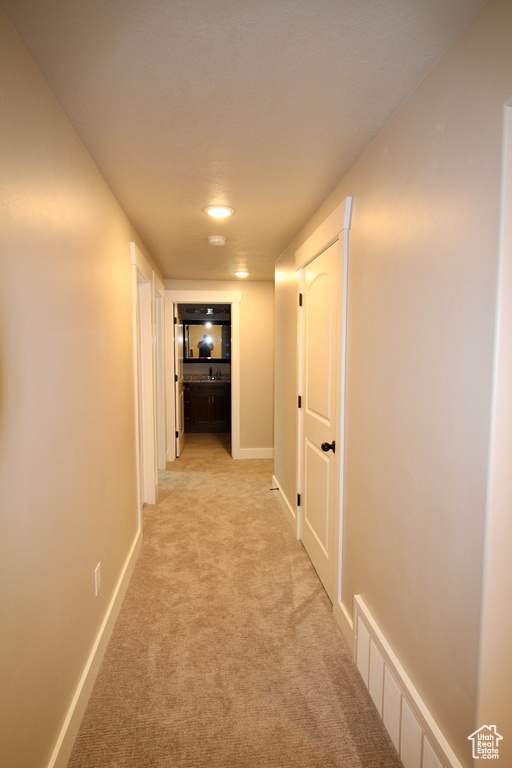 Hallway with light colored carpet