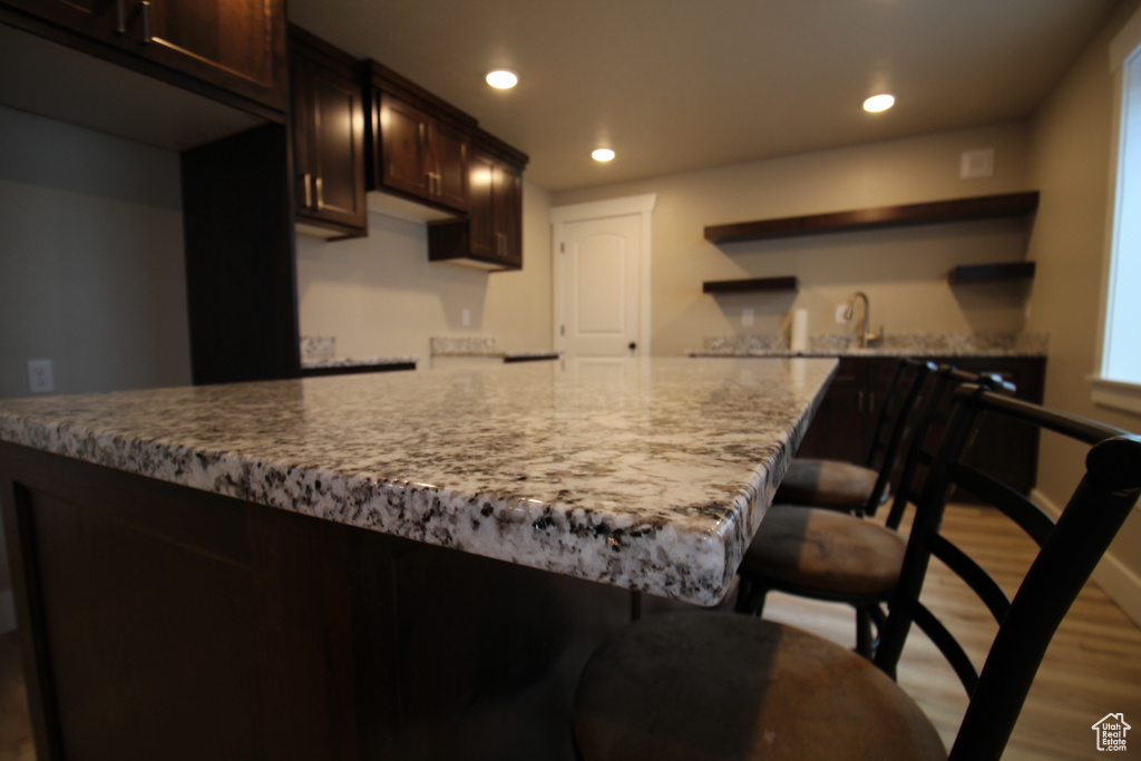 Kitchen featuring dark brown cabinets and hardwood / wood-style floors