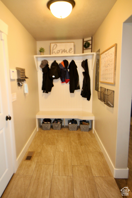 Mudroom with tile patterned floors