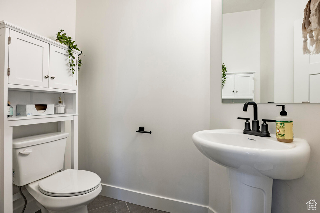 Bathroom with tile patterned floors and toilet