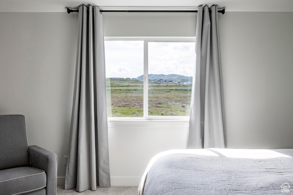 Carpeted bedroom with a mountain view