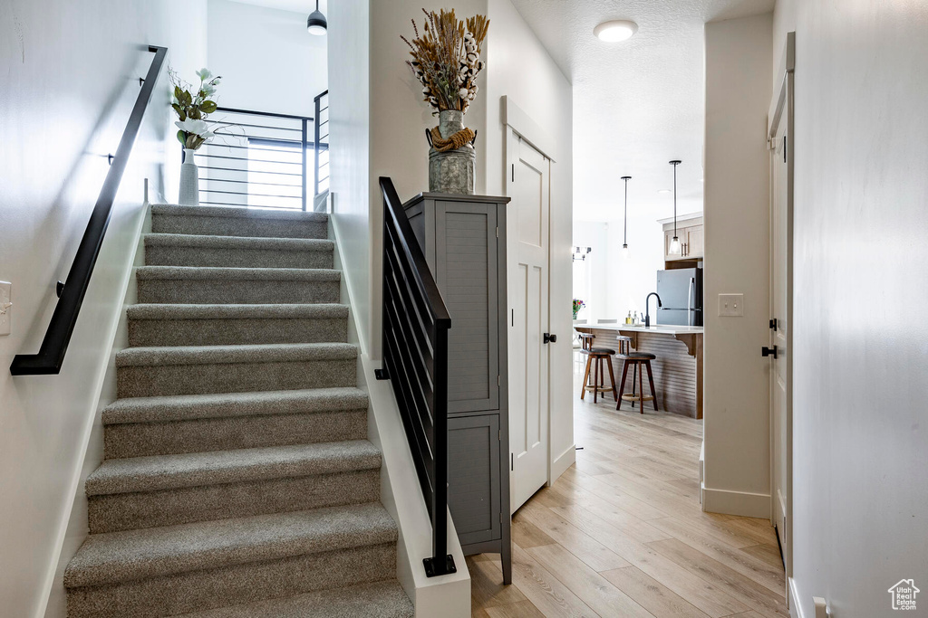 Staircase with light wood-type flooring