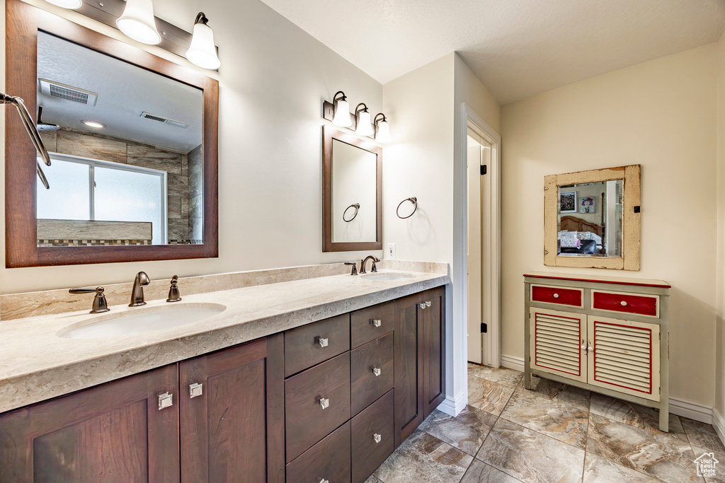 Bathroom with dual vanity and tile patterned floors