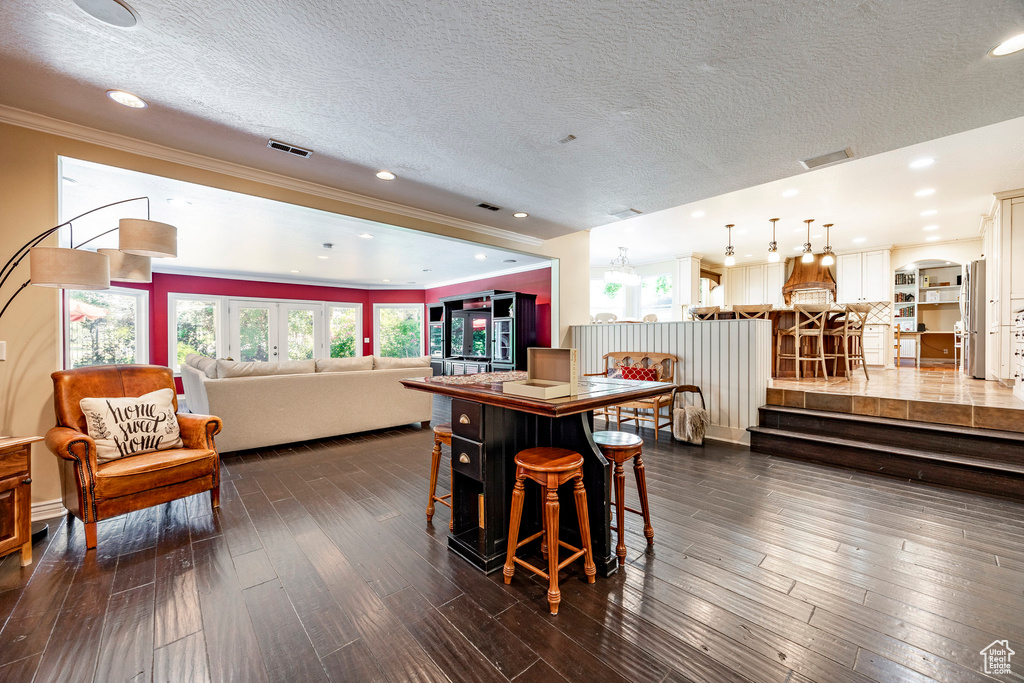 Dining area featuring dark hardwood / wood-style flooring, a textured ceiling, and french doors