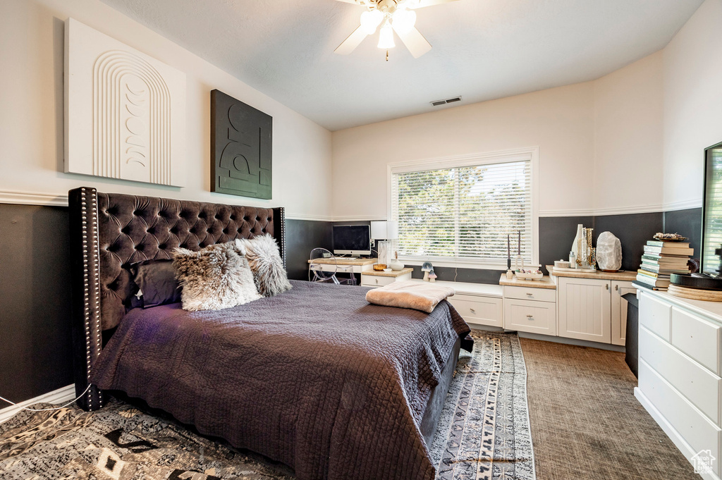 Carpeted bedroom featuring ceiling fan