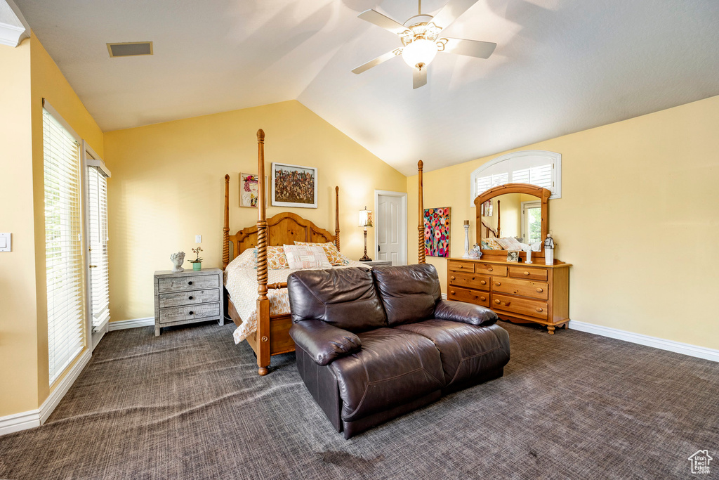 Carpeted bedroom featuring ceiling fan and lofted ceiling