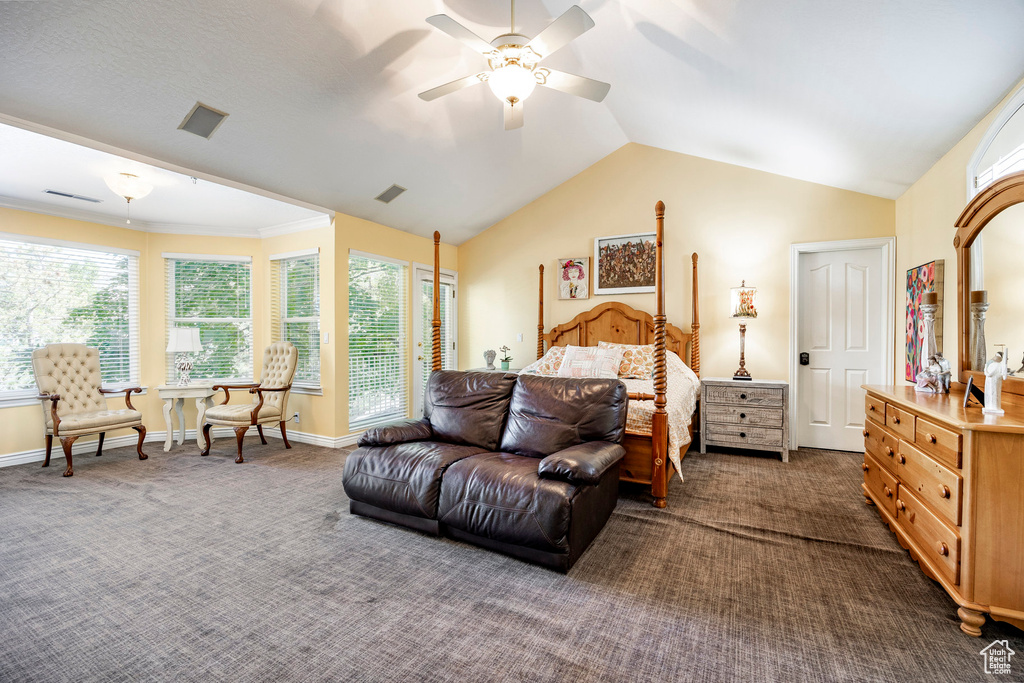 Carpeted bedroom featuring ceiling fan and lofted ceiling