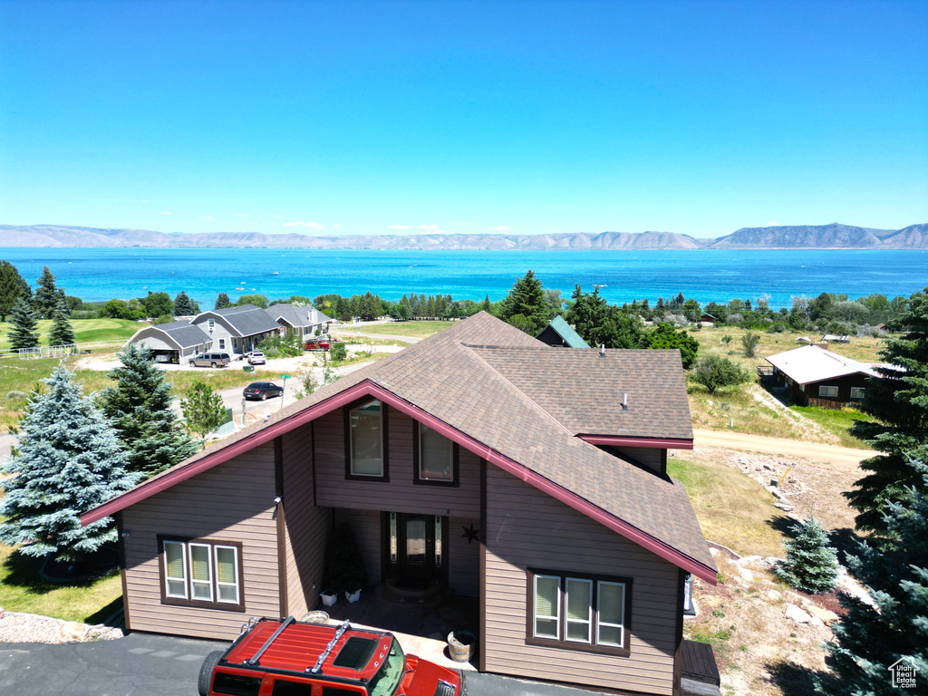 Birds eye view of property with a water and mountain view