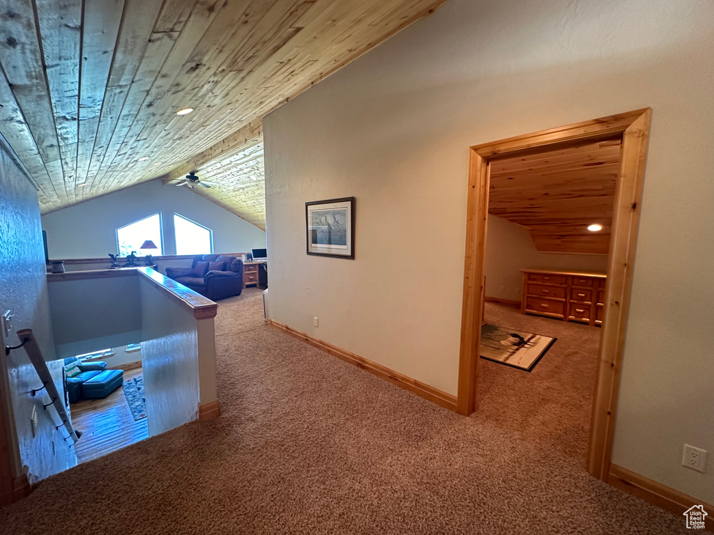 Home office with lofted ceiling and carpet floors