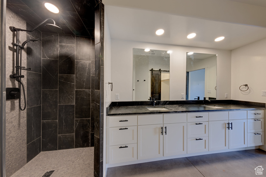 Bathroom featuring vanity and a tile shower