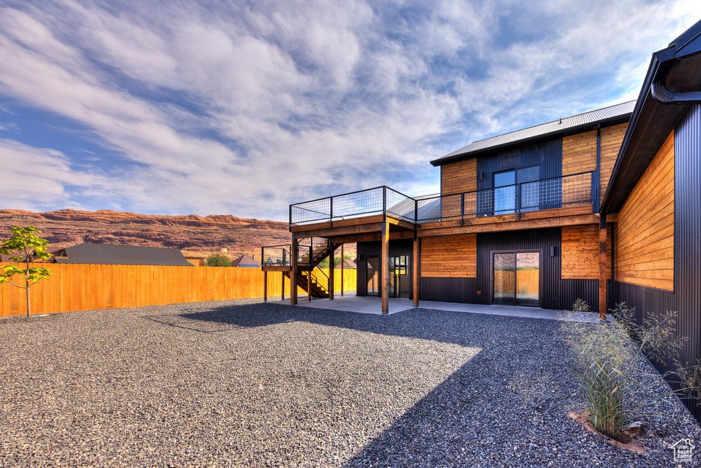 Back of house with a patio and a mountain view