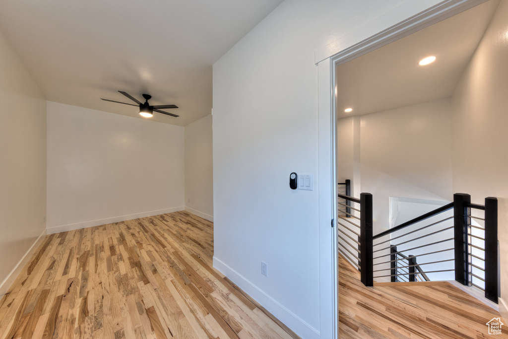 Empty room featuring light wood-type flooring and ceiling fan