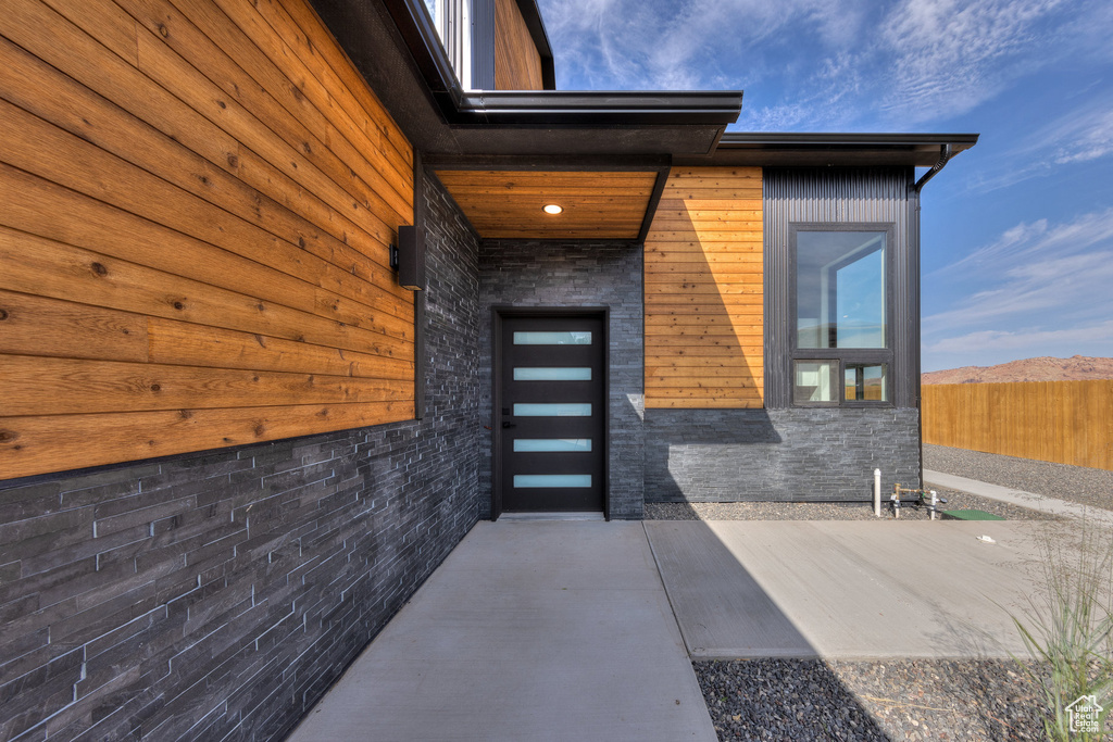 Property entrance featuring a mountain view and a patio area