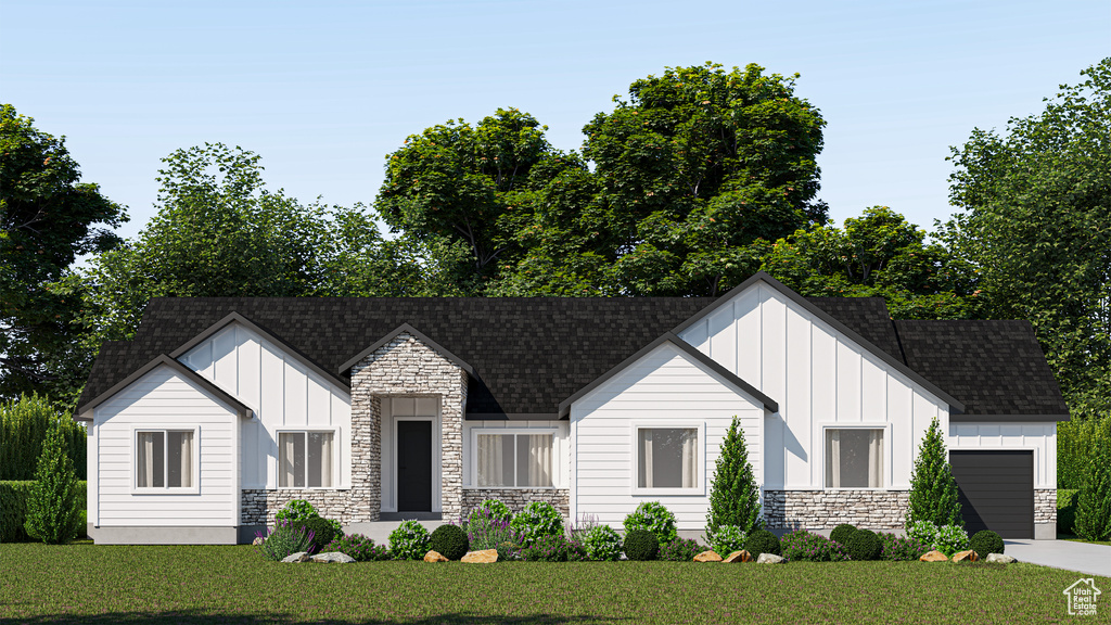 View of front of home with a garage and a front lawn