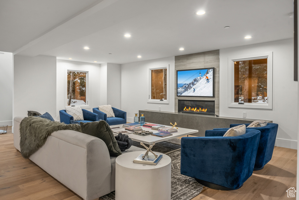 Living room with light hardwood / wood-style flooring and a large fireplace