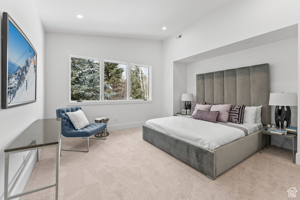 Bedroom featuring lofted ceiling and light colored carpet