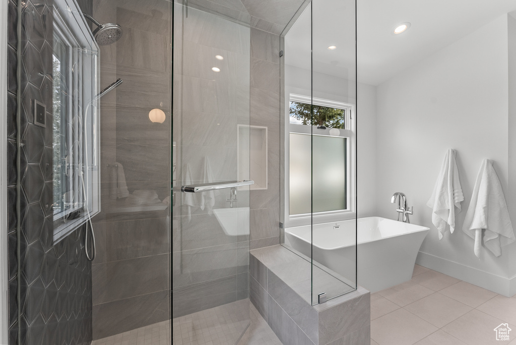 Bathroom featuring tile patterned floors and separate shower and tub