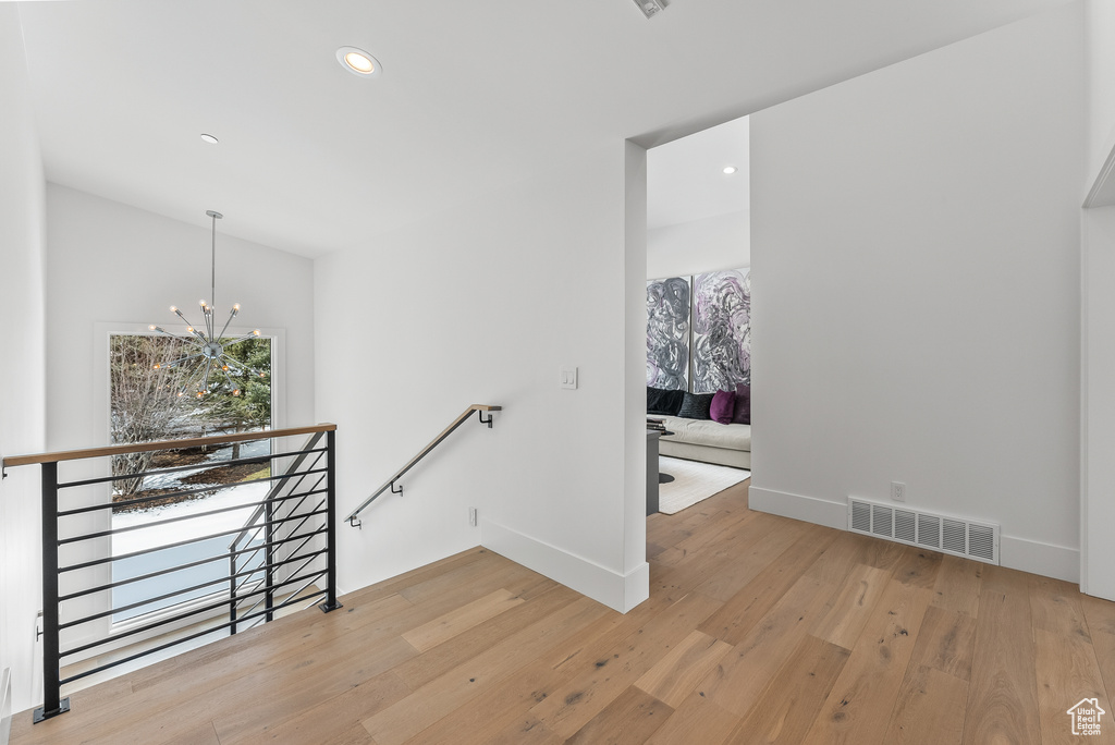 Interior space with light wood-type flooring and a notable chandelier