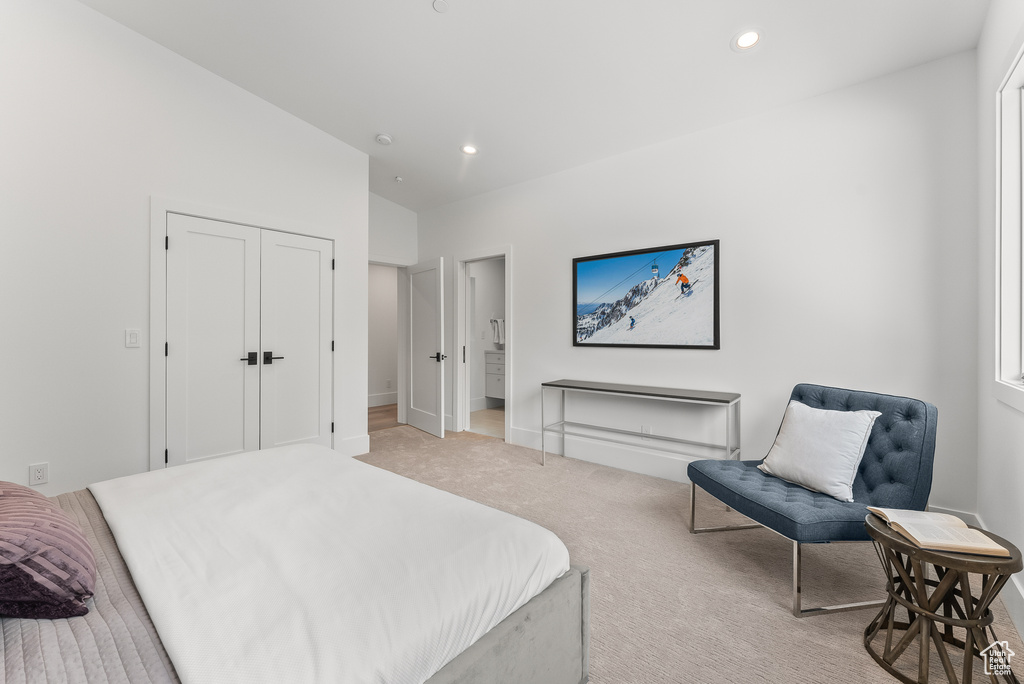 Bedroom with light carpet and vaulted ceiling