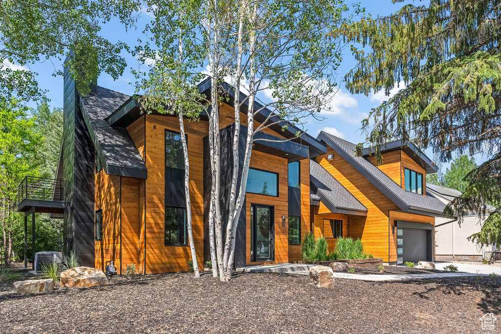 Modern home featuring a garage and central AC