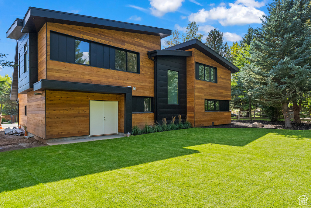 Rear view of property featuring a yard