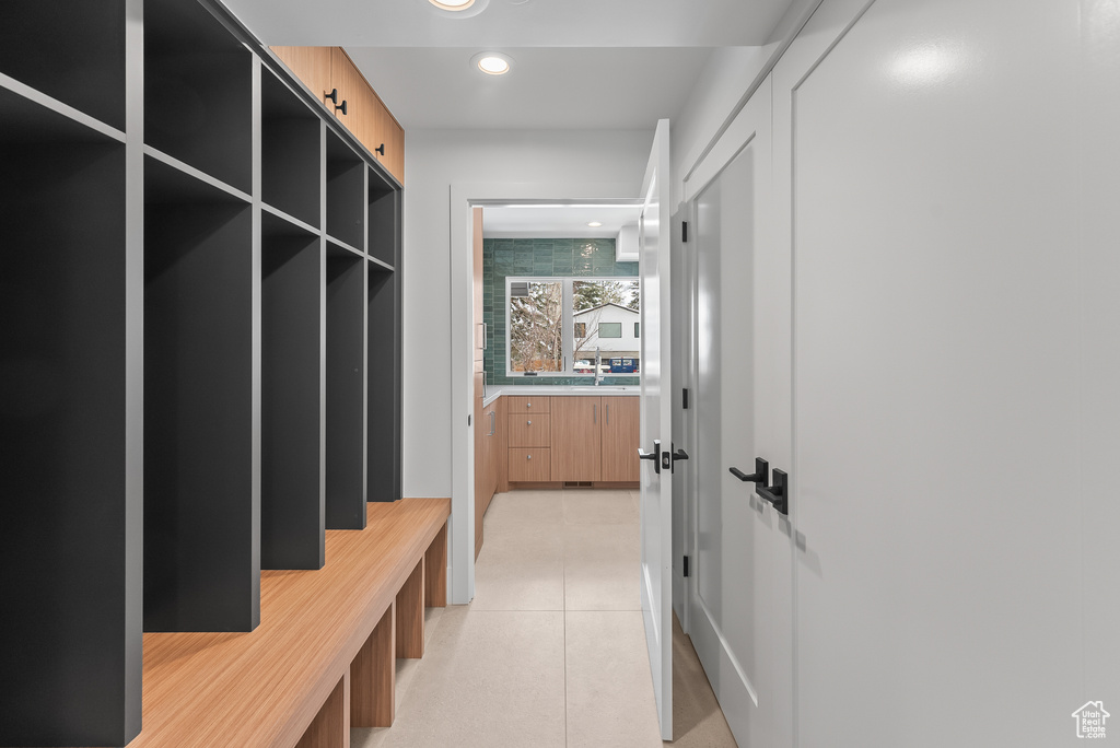 Mudroom with light tile patterned flooring