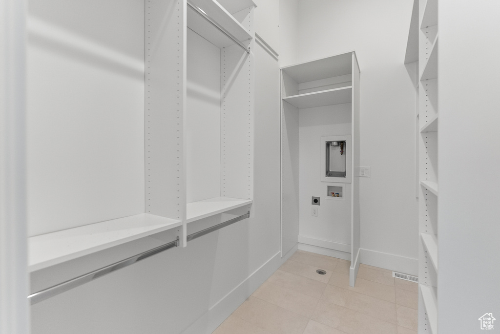 Spacious closet featuring light tile patterned floors