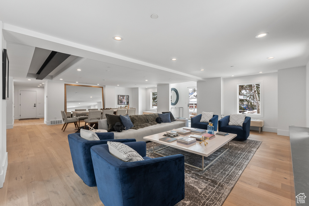 Living room featuring beamed ceiling and light wood-type flooring