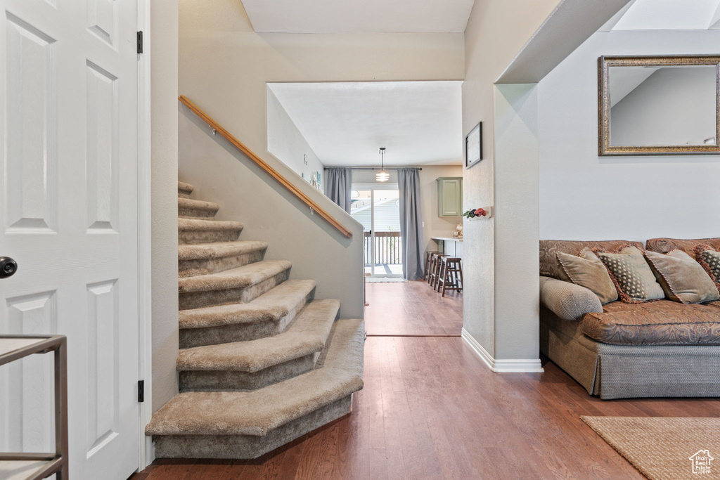 Staircase featuring wood-type flooring