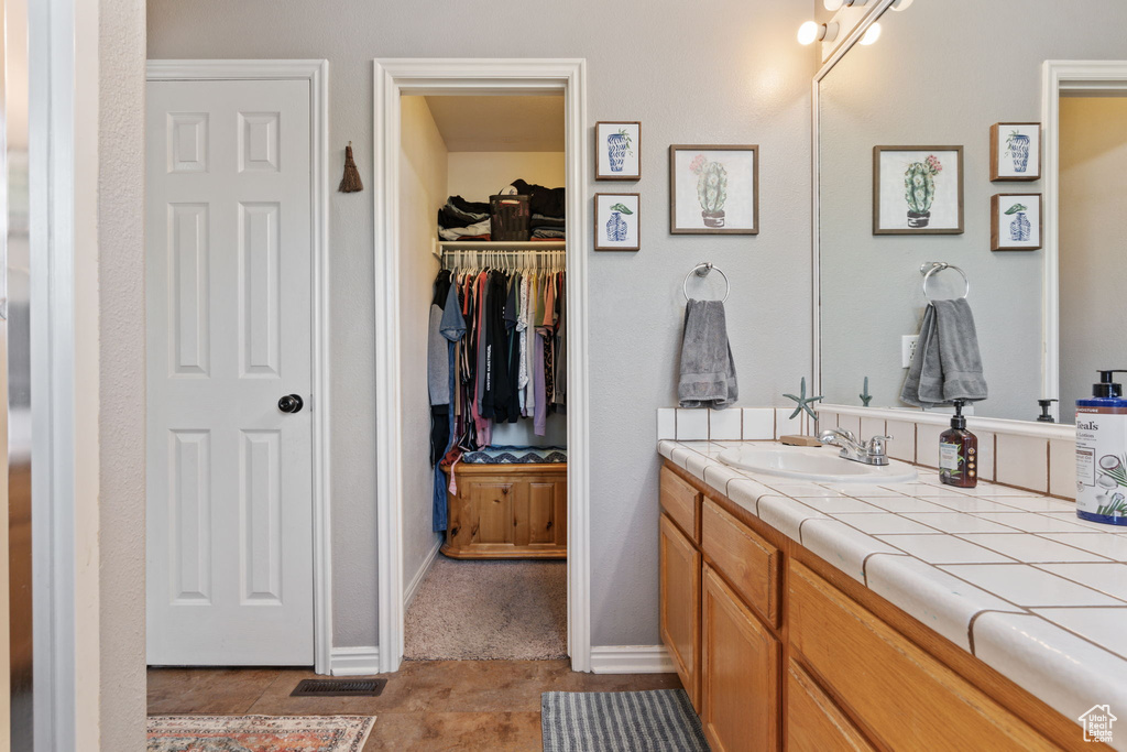 Bathroom with vanity and tile patterned floors