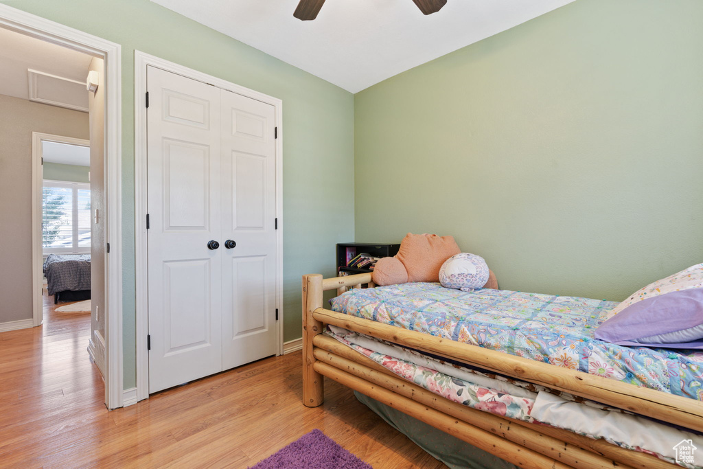 Bedroom featuring light hardwood / wood-style flooring, a closet, and ceiling fan