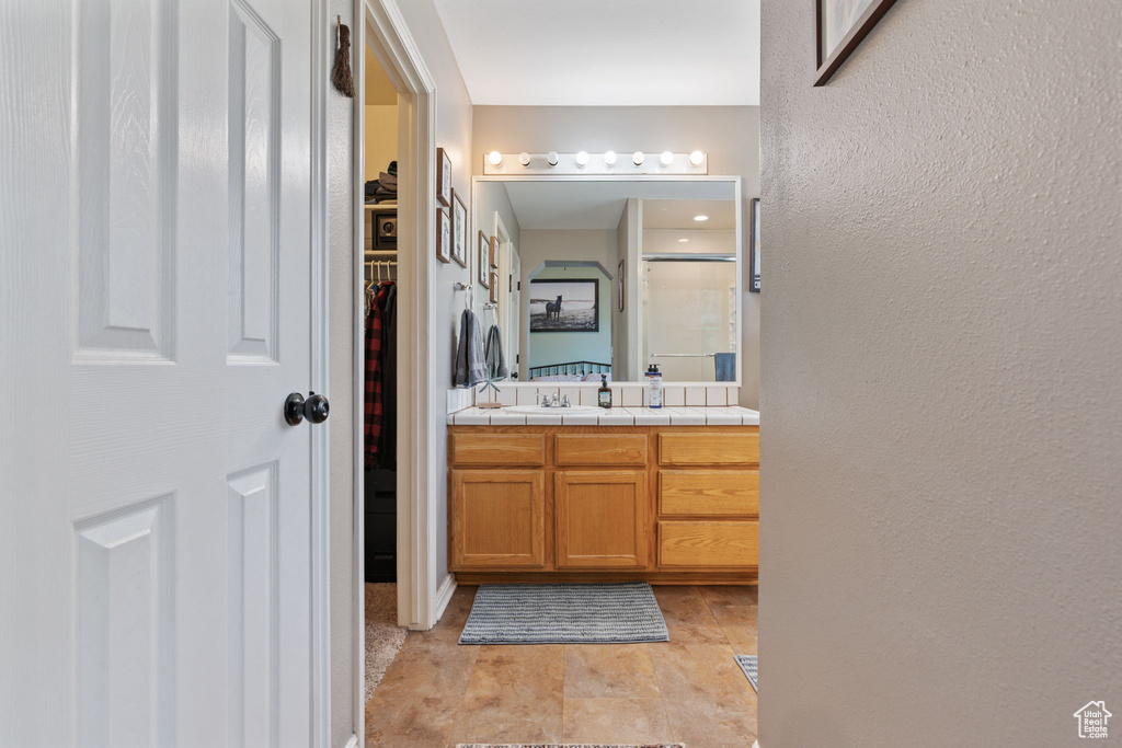 Bathroom with tile patterned flooring and vanity