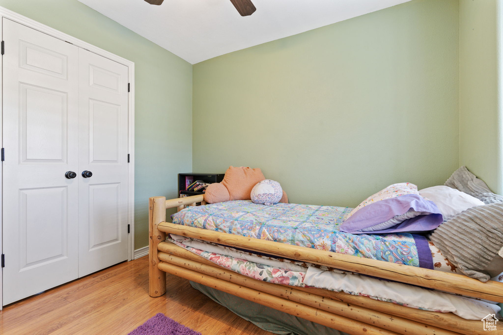 Bedroom featuring a closet, hardwood / wood-style flooring, and ceiling fan