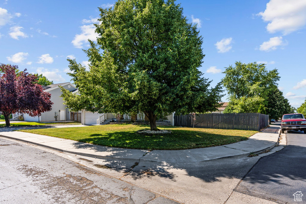 View of front of home featuring a garage and a front lawn