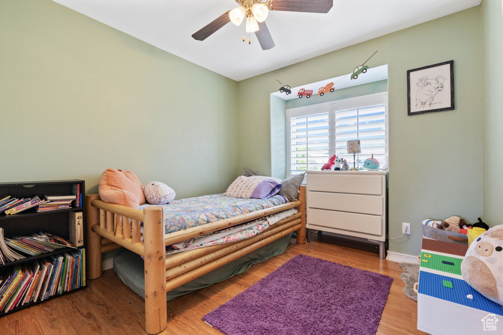 Bedroom featuring wood-type flooring and ceiling fan