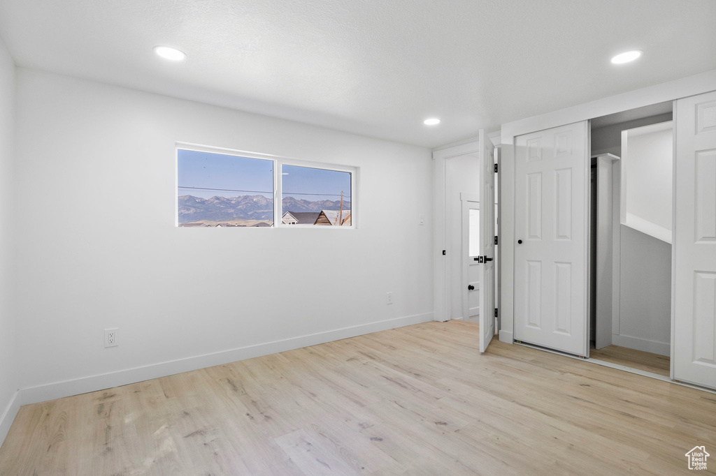 Unfurnished bedroom with a closet and light wood-type flooring