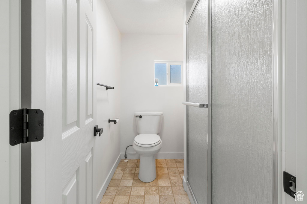 Bathroom with tile patterned flooring and toilet