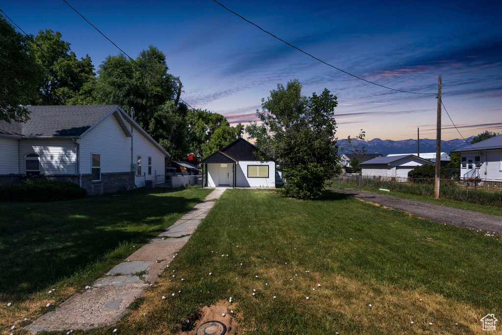 Exterior space with a garage and a yard