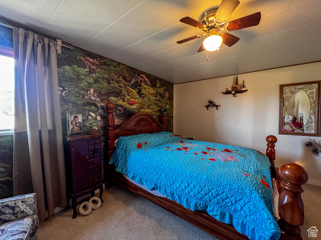 Bedroom featuring a textured ceiling, carpet, and ceiling fan