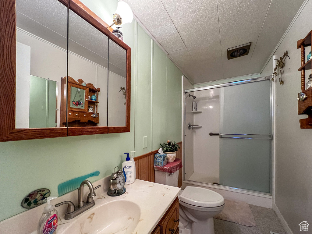 Bathroom with vanity, toilet, tile patterned flooring, and walk in shower