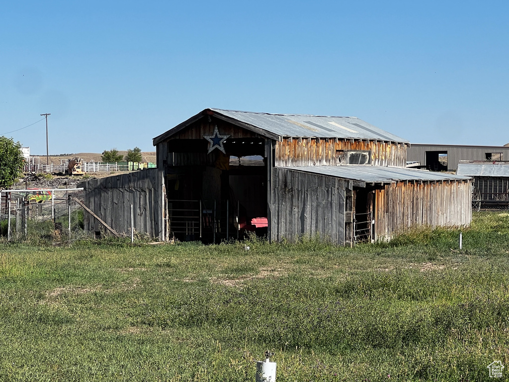 View of outbuilding with a lawn