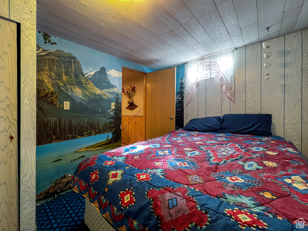 Bedroom featuring wooden walls