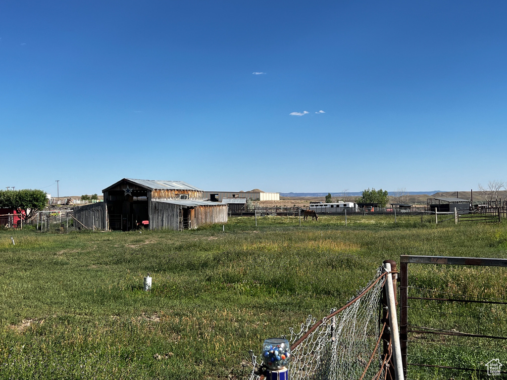 View of yard with an outbuilding and a rural view