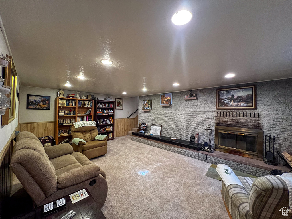 Carpeted living room featuring a brick fireplace