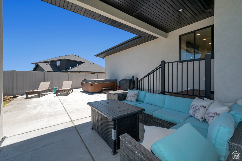 View of patio / terrace with an outdoor living space and a hot tub