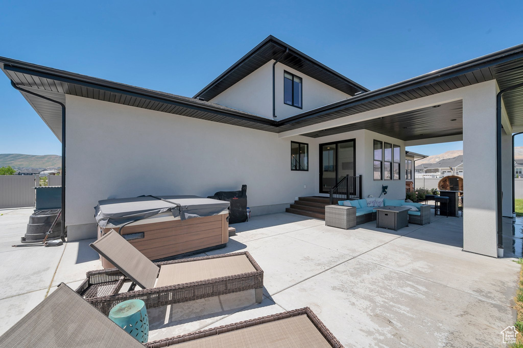 View of patio / terrace with an outdoor living space and a hot tub